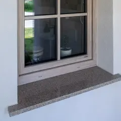 Zewnętrzny parapet z granitu wystaje ok. 5 cm, zapewniając ochronę i estetykę okna.