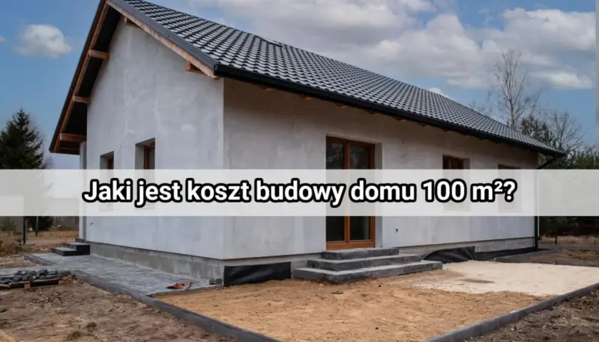 Szary, nieotynkowany dom w trakcie budowy. Na elewacji tekst: "Jaki jest koszt budowy domu 100 m²?".